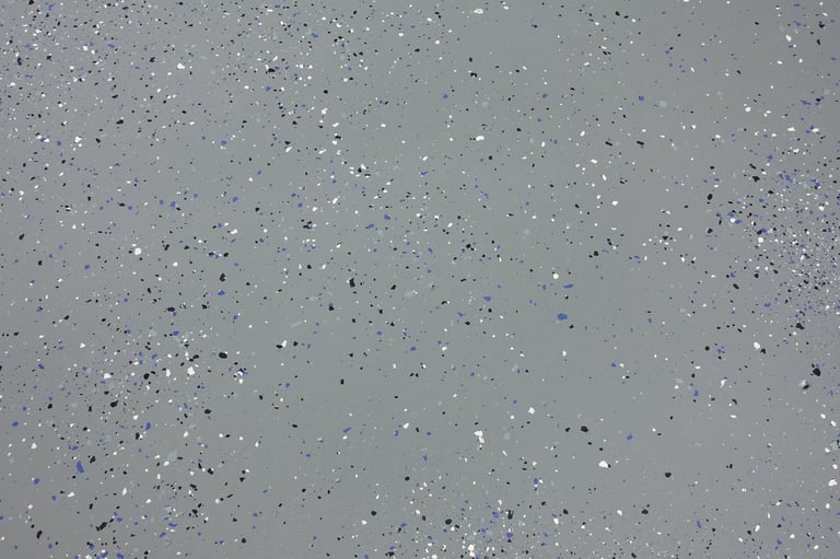 Gray epoxy floor finish with blue, black and white plastic chips